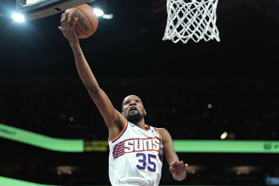 Phoenix Suns forward Kevin Durant (35) makes a layup against the Philadelphia 76ers during the first half at Footprint Center in Phoenix on March 20, 2024.