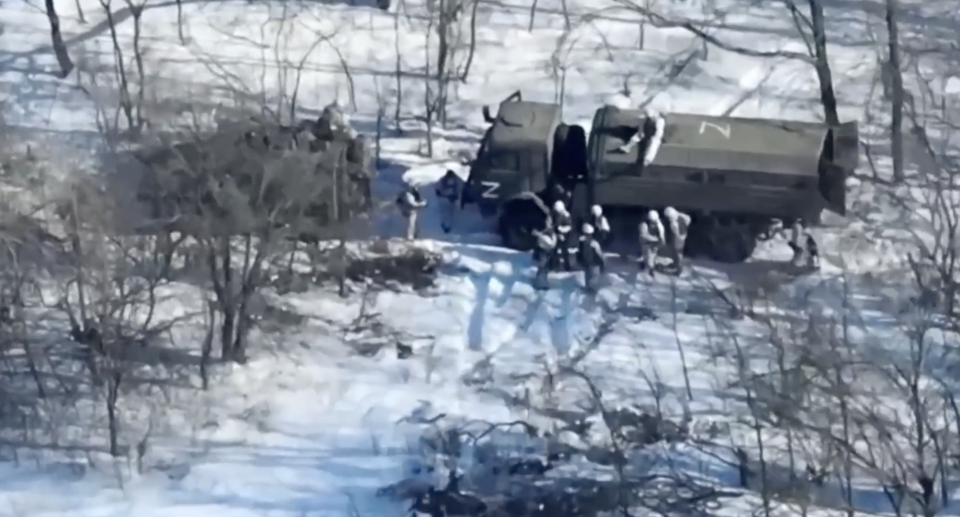 The footage was captured by a Ukrainian drone and shows several Russian troops standing around two military vehicles. Source: Newsflash