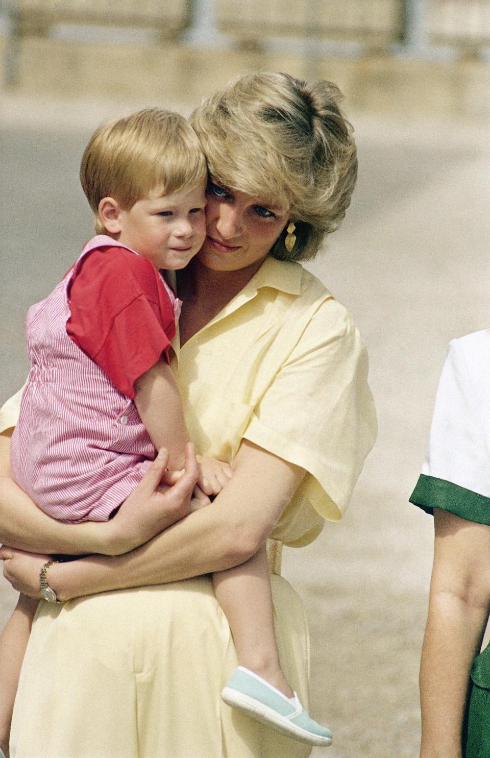 Princess Diana holds Harry in this photo just before his third birthday in 1987.