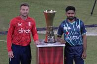 England's cricket team skipper Jos Buttler, left, and his Pakistani counterpart Babar Azam pose for photograph with the trophy of twenty20 cricket matches series, at the National stadium, in Karachi, Pakistan, Monday, Sept. 19, 2022. (AP Photo/Anjum Naveed)