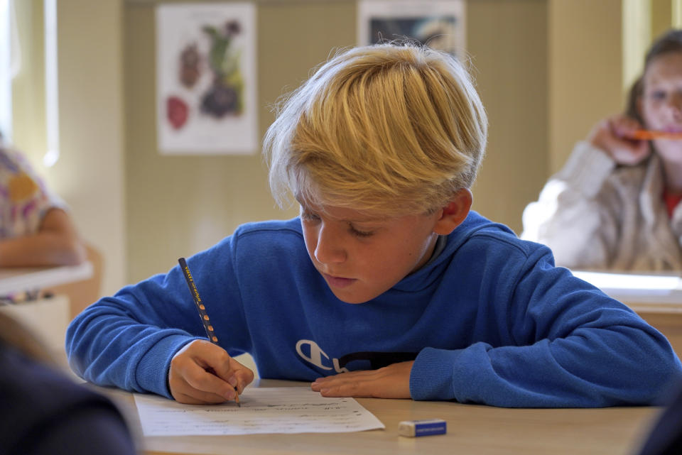 A child practices handwriting at the Djurgardsskolan elementary school in Stockholm, Sweden, Thursday, Aug. 31, 2023. As children across Sweden have recently flocked back to school after the summer vacation, many of their teachers are putting a new emphasis on printed books, quiet reading hours, and practicing handwriting as the country's yearslong focus on the digitalization of classrooms has come under scrutiny. (AP Photo/David Keyton)