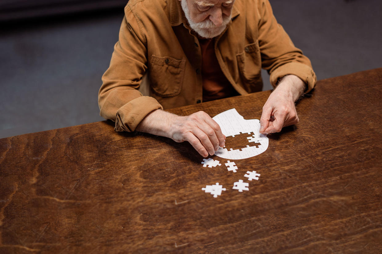 Senior man doing a jigsaw puzzle Getty Images/LightFieldStudios