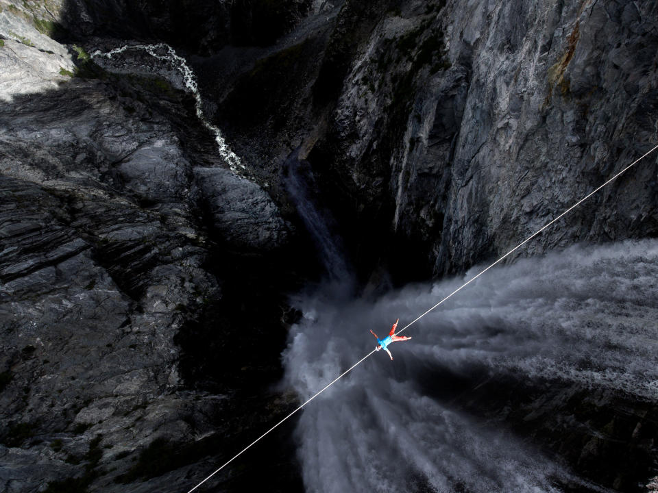 Lukas Irmler takes a break on a high wire across Hunlen Falls in British Columbia, Canada. (Photo: Valentin Rapp/Caters News)