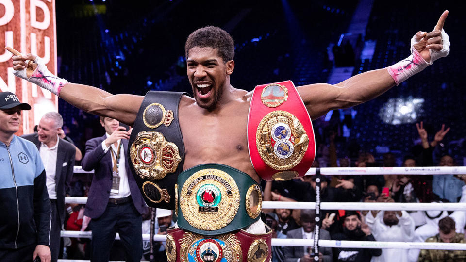 Pictured here, Anthony Joshua celebrates with his heavyweight titles.
