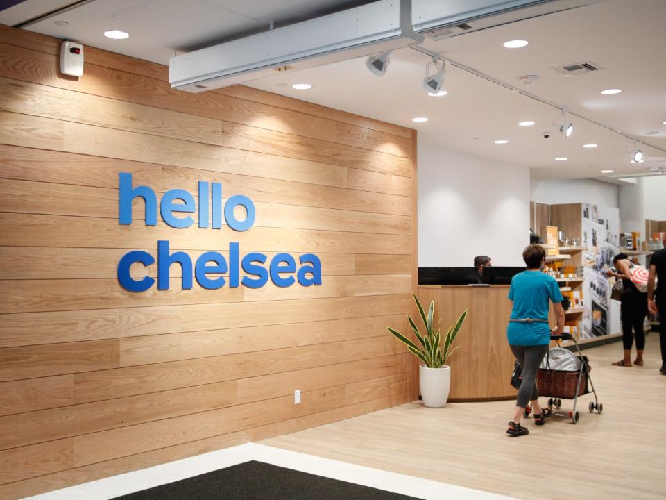 a sign that says "Hello Chelsea" by the entrance of teh store