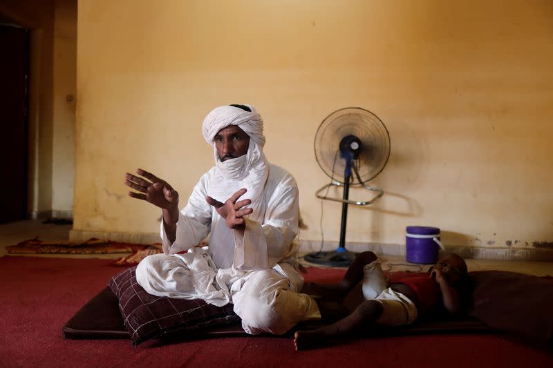 Algateig Mohamed, who fled Inates town with his family to escape jihadist violence, gestures during an interview with Reuters journalists as he sits at his shelter in Niamey