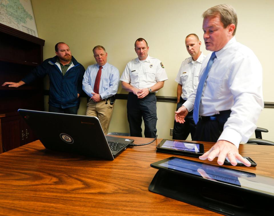 Then-Tuscaloosa County EMA director Rob Robertson demonstrates the new TuscAlert system that will allow emergency notifications to be tailored to specific locations Tuesday, March 28, 2017. Viewing the demonstration from left are Tuscaloosa County engineer Scott Anders, Northport Police assistant chief Keith Carpenter, Tuscaloosa Fire and Rescue Lt. Drew Stephenson and Tuscaloosa Fire and Rescue battalion chief Jim Ray.