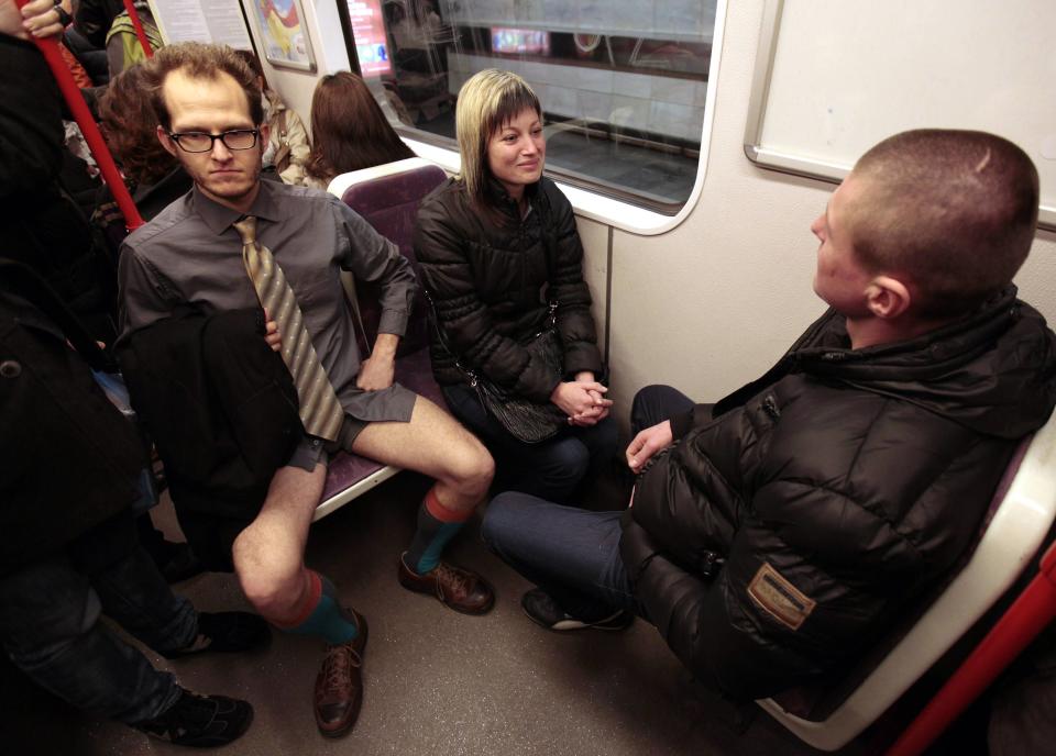 A passenger, not wearing pants, sits on a subway train during the "No Pants Subway Ride" in Prague