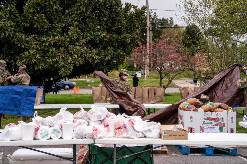 Maryland National Guard members prepare a food distribution site for the needy in Stevensville, Md., on April 17. | Peter van Agtmael—Magnum Photos for TIME