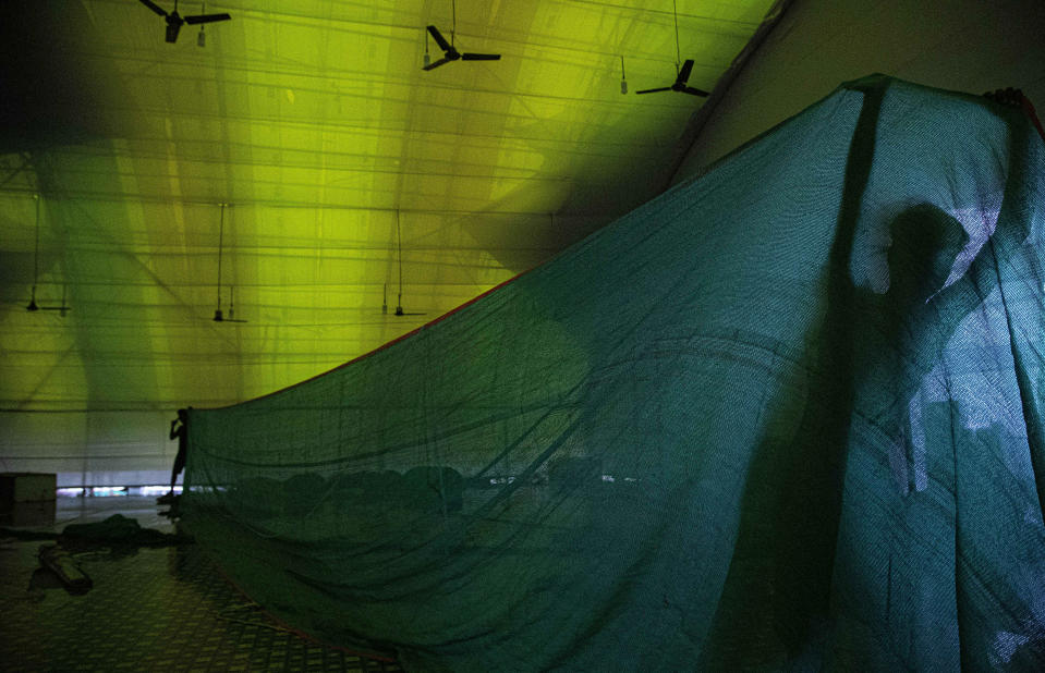 Indian laborers work to build a new quarantine center in Gauhati, India, Sunday, June 14, 2020. India’s coronavirus caseload has jumped by about 100,000 in a week, coinciding with the reopening of shopping malls, houses of worship and restaurants. The government had imposed a nationwide lockdown in late March. (AP Photo/Anupam Nath)