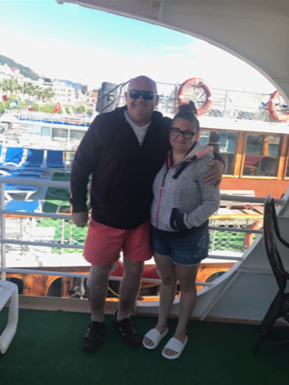 Couple pose on a boat together