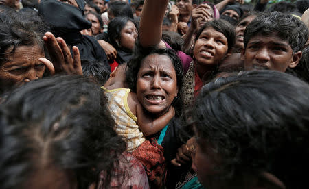 A woman reacts as Rohingya refugees wait to receive aid in Cox's Bazar, Bangladesh, September 21, 2017. REUTERS/Cathal McNaughton