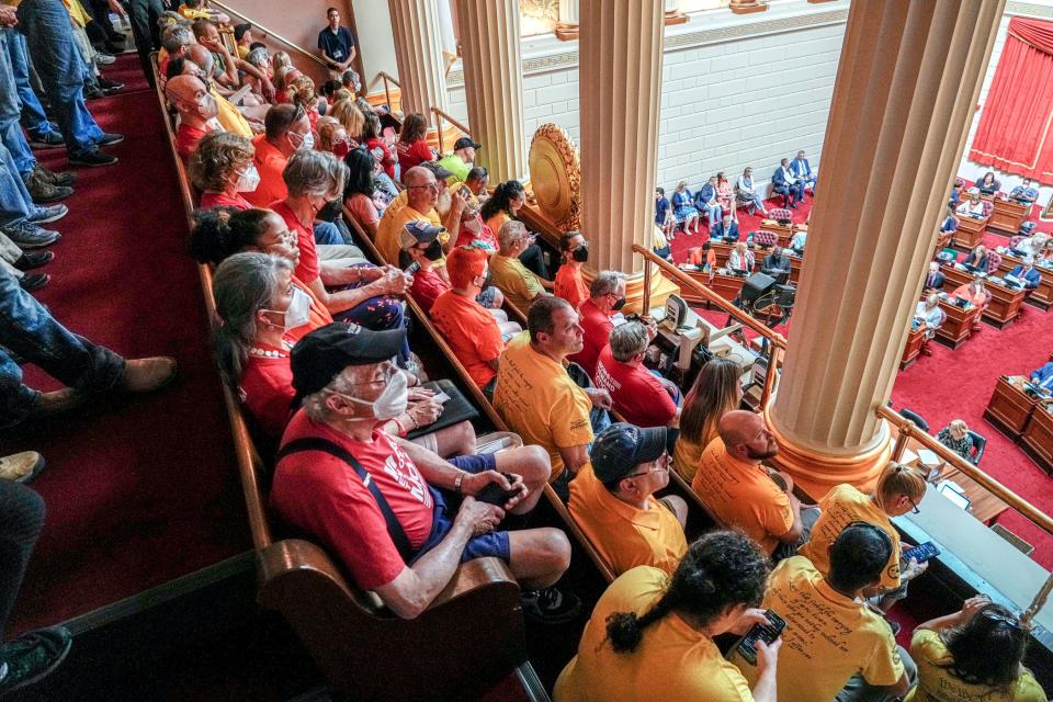 The public was allowed to sit in the House chamber balcony during Friday's floor debate, with gun-rights advocates, often in yellow T-shirts, sitting alongside gun-safety advocates, often in red T-shirts.