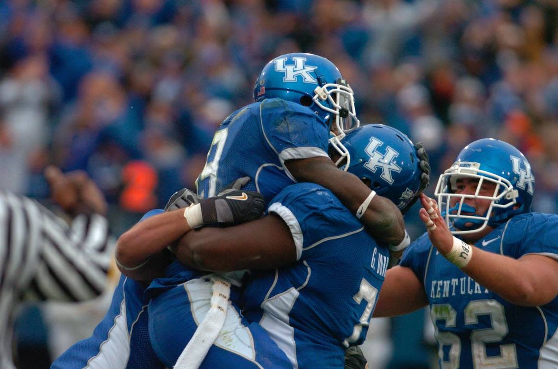 UK’s Keenan Burton, left, is congratulated by teammates Garry Williams, center, and Matt McCutchan after Burton’s TD catch in the fourth quarter made the score (with the extra point) 17-14 in favor of the Cats against Georgia on Nov. 4, 2006, at Commonwealth Stadium. Kentucky won 24-20.
