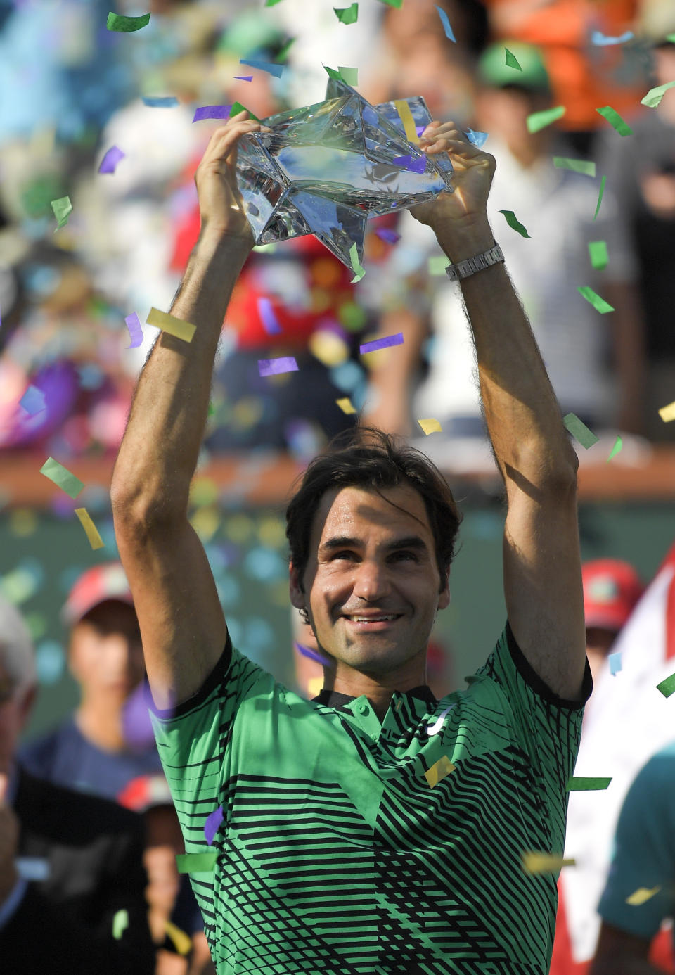 Roger Federer, of Switzerland, celebrates his 6-4, 7-5 win over Stan Wawrinka, of Switzerland, in the men's final of the BNP Paribas Open tennis tournament, Sunday, March 19, 2017, in Indian Wells, Calif. (AP Photo/Mark J. Terrill)