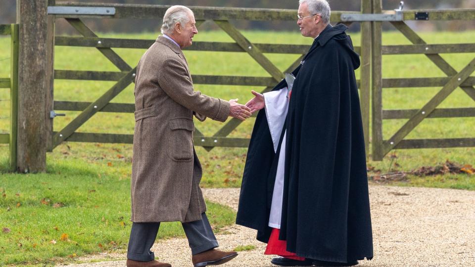 king shaking hands with reverend 