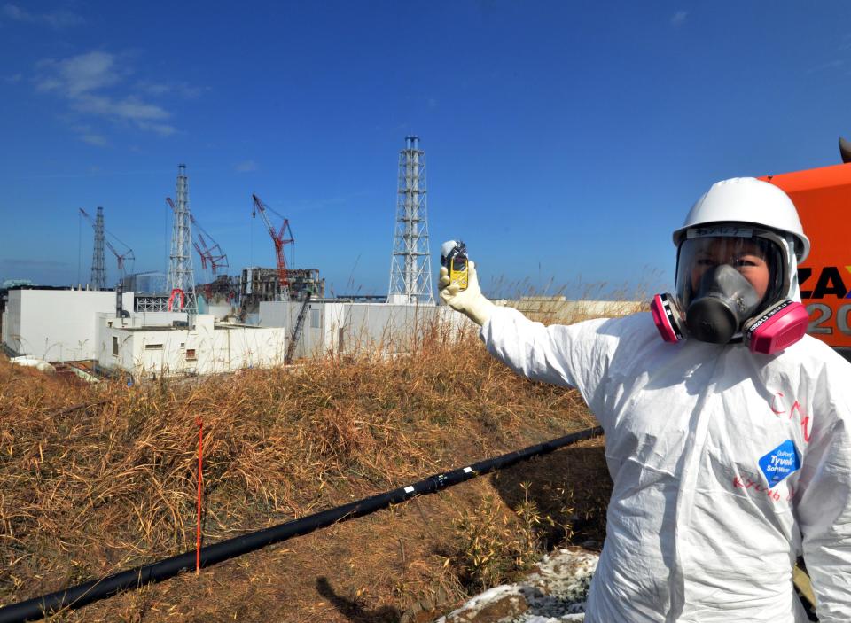 A journalist checks radiation level with her dosimeter near stricken Fukushima Dai-ichi nuclear power plant of Tokyo Electric Power Co., during a press tour led by TEPCO officials, in Okuma town, Fukushima prefecture, northeastern Japan Tuesday, Feb. 28, 2012. Japan next month marks one year since the March 11 tsunami and earthquake, which triggered the worst nuclear accident since Chernobyl in 1986.  (AP Photo/Yoshikazu Tsuno, Pool)