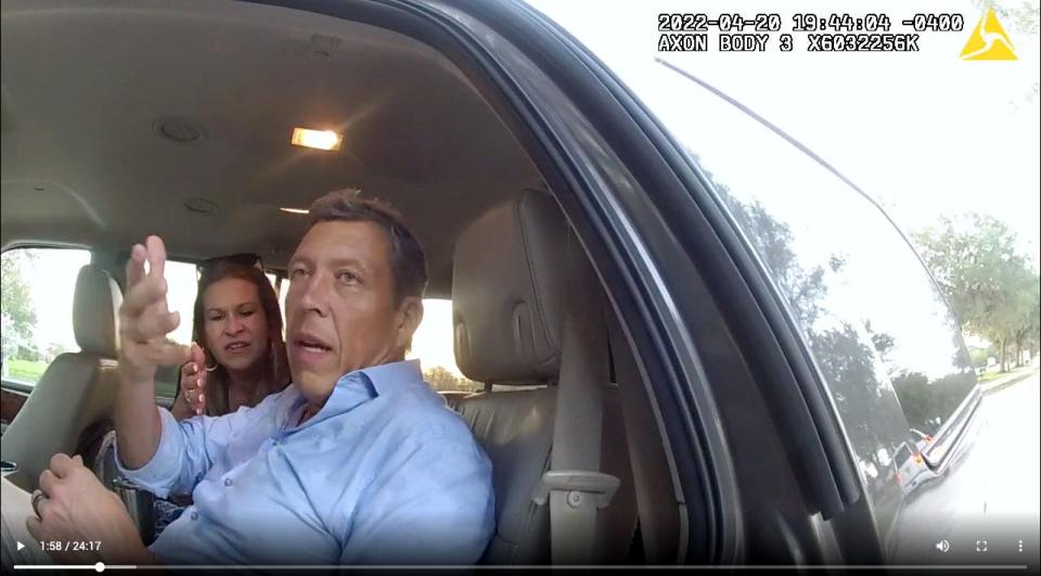 A still frame from a Manatee County Sheriff deputy's body cam shows Manatee County Commissioner George Kruse sitting in his wife's car after he crashed his truck into a tree on April 20, 2022. 