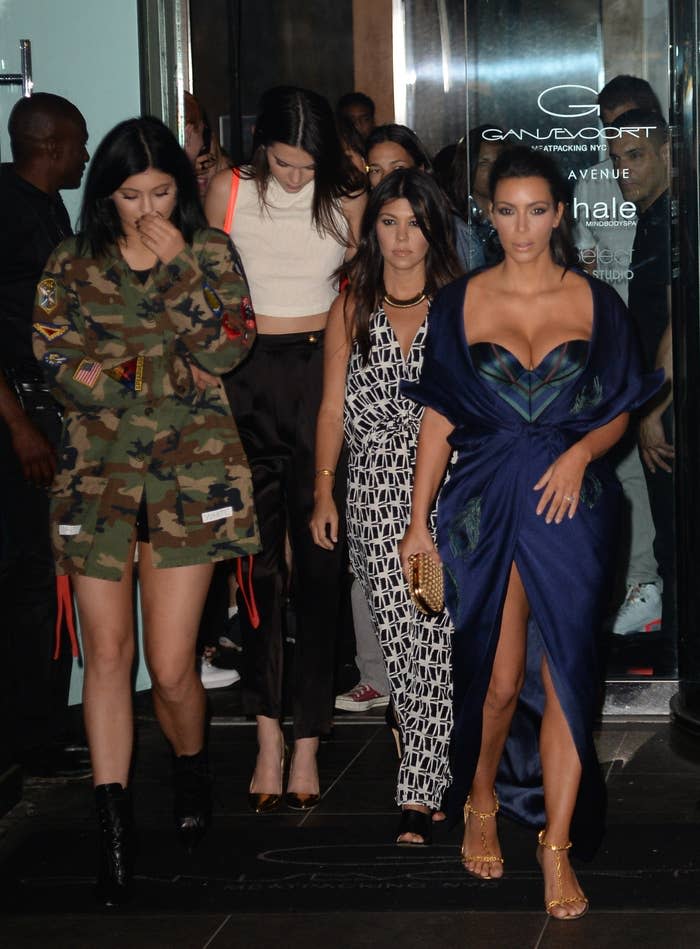 Kourtney Kardashian, Kendall Jenner, and Kim Kardashian exiting a building