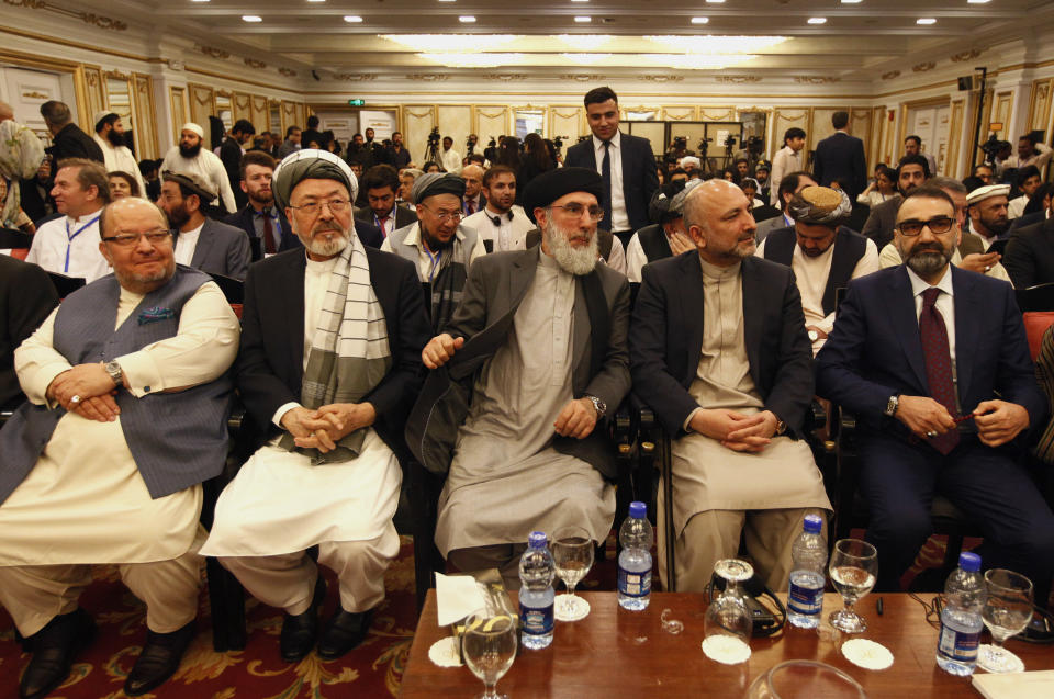 Afghan politicians, from second left to right, Mohammad Karim Khalili, Gulbuddin Hekmatyar, Haneef Atmar and Ustad Atta Mohammad Noor, and others attend the opening session of an Afghan Peace Conference in Bhurban, 65 kilometers (40 miles) north of Islamabad, Pakistan, Saturday, June 22, 2019. Dozens of Afghan political leaders attended a peace conference in neighboring Pakistan on Saturday to pave the way for further Afghan-to-Afghan dialogue. (AP Photo/Anjum Naveed)