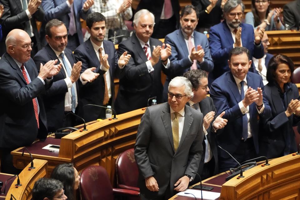 Member of parliament Jose Aguiar Branco, left on front row, of the Social Democratic Party, is applauded after being elected house speaker in Lisbon, Wednesday, March 27, 2024. Portugal's newly-elected Parliament Wednesday voted in a new house speaker following a deal between the country's two main centrist parties. (AP Photo/Armando Franca)