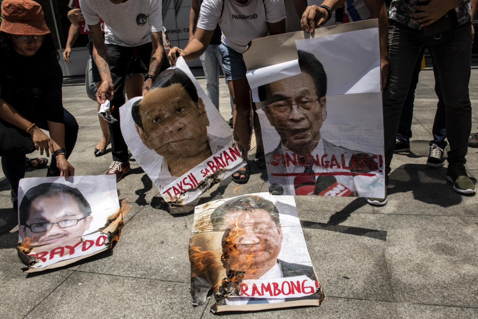 Protesters burn images of Chinese president Xi Jin Ping, Philippines president Rodrigo Duterte, and local government officials on June 25, 2019 in front of the Chinese Embassy in Makati, Philippines. (Photo by Jes Aznar/Getty Images)