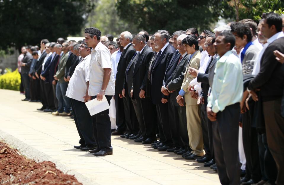 Relatives and friends perform final prayers during the burial of Kenyan journalist Sood, who was killed in the Westgate shopping mall attack, in Nairobi