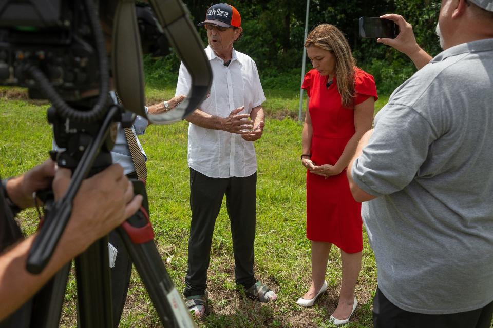 Irv Slosberg and Emily Slosberg-King speak at a former memorial site where Dori Slosberg and four others were killed in a 1996 crash on Palmetto Park Road just west of the Florida Turnpike in unincorporated Palm Beach County, Fla., on August 24, 2023. Dori was Irv's daughter and Emily's twin sister. The memorial had four Christian crosses and a Star of David for the victims that had been installed in concrete, Irv said.