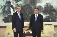 Britain's Chancellor of the Exchequer Philip Hammond, left, meets with Chinese Premier Li Keqiang as they pose for media before their meeting at the Diaoyutai State Guesthouse, Friday, April 26, in Beijing. (Parker Song/Pool Photo via AP)