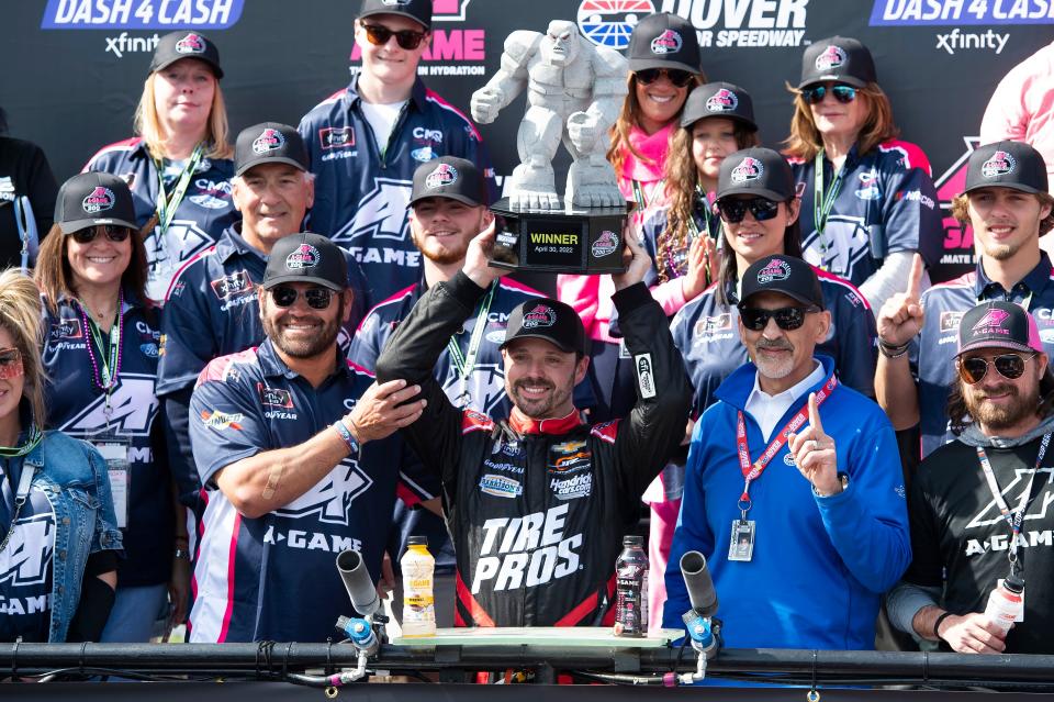 Josh Berry (8) holds up the trophy in Victory Lane after winning the NASCAR Xfinity Series auto race at Dover International Speedway, Saturday, April 30, 2022, in Dover, Del. (AP Photo/Jason Minto)