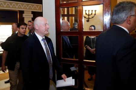 Jason Greenblatt (C), U.S. President Donald Trump's Middle East envoy, is reflected in a mirror as he enters a room to hold a news conference in Jerusalem July 13, 2017. REUTERS/Ronen Zvulun