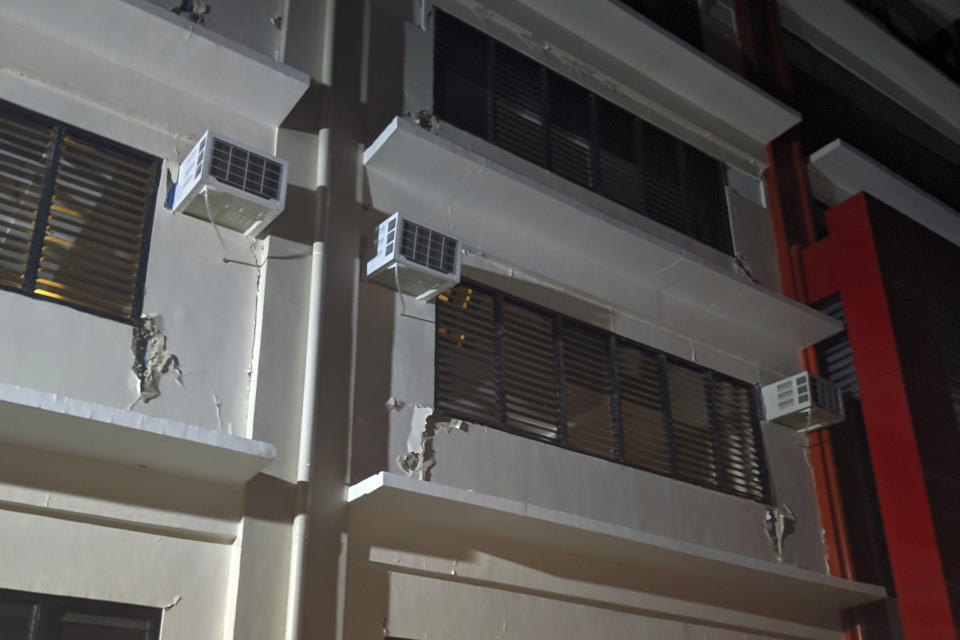 Cracks are seen on the walls of a damaged building in Digos, Davao del Sur province, southern Philippines on Wednesday Oct. 16, 2019. A powerful and shallow earthquake hit several southern Philippine provinces Wednesday night injuring some people in collapsed houses and prompting thousands to scramble out of homes, shopping malls and a hospital in panic, officials and news reports said. (AP Photo/Romell Bacongco)