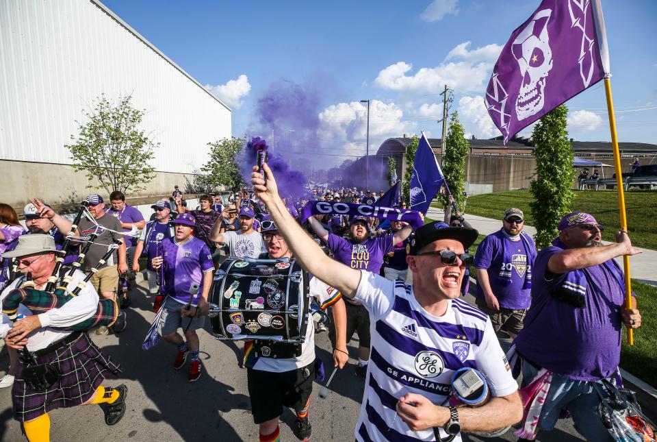 Singing 'We Love You and Where You Go We'll Follow' as bagpipes played and purpler smoke streamed, The Coopers whooped and hollered as a group of 75 fans marched from Ten20Craft Brewery on Washington Street to the soccer stadium before Louisville City FC took on Memphis 901 FC. The professional soccer club of the USL celebrated their 'Grand Opening' Saturday evening a year after Covid-19 derailed it in 2020. June 12, 2021