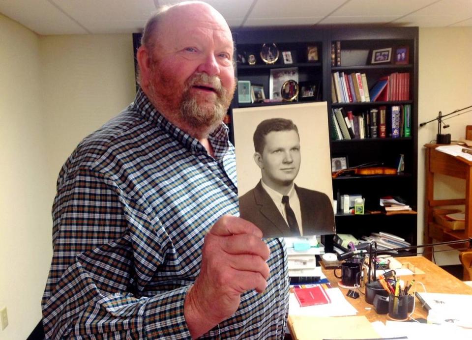 Robert “Bob” Wadkins Sr. holds up his high school photo, in 2013 when he retired from leading the Chattahoochee Judicial Circuit Public Defender’s Office.