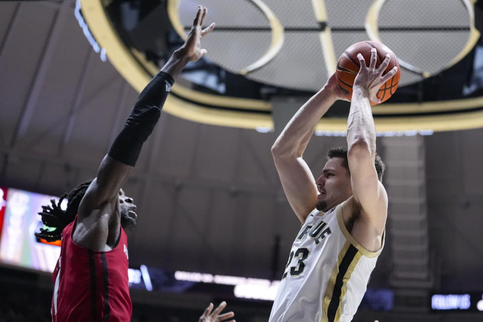 Purdue forward Camden Heide (23) shoots around Rutgers center Clifford Omoruyi (11) during the second half of an NCAA college basketball game in West Lafayette, Ind., Thursday, Feb. 22, 2024. (AP Photo/Michael Conroy)