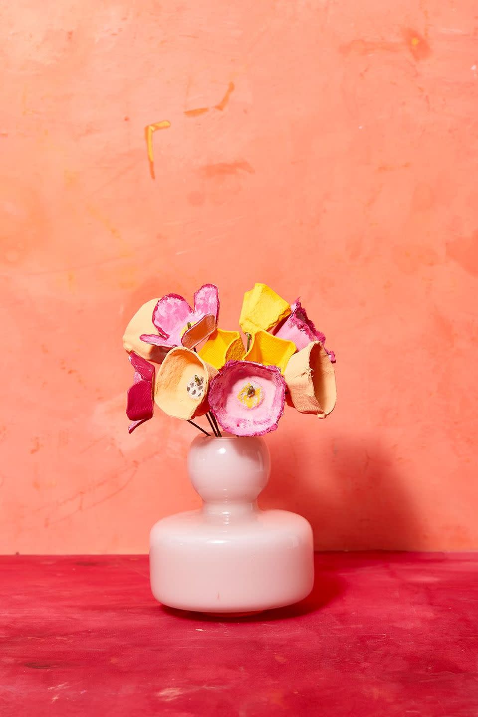 <p>Assemble a bouquet of egg carton flowers that she can enjoy well beyond Mother's Day. Our advice: Have the adults cut out the "flowers" first and let kids get creative with paint!</p><p><strong>Follow these step-by-step instructions:</strong></p><ol><li>Cut off the top of the egg carton and the extra flap on the other edge.</li><li>Cut out the center columns from the carton by making small cuts with your X-Acto knife.</li><li>Cut out what is left on the carton to use as egg cups.</li><li>Using the center columns you cut out, clean up the edge of the opening with your scissors.</li><li>Paint the columns both inside and out with some thinned out acrylic paint for a washed look.</li><li>Using the egg cups, cut around the top of the cup to make it the same size all around or rip the top edge with your fingers to get a more rough look.</li><li>Paint the cup with your thinned out acrylic paint for a flower look.</li><li>For a petaled look, cut down the 4 corners of the cup and clean up using your scissors and rounding the tops of each petal before painting.</li><li>Keep the stem in place by attaching floral wire to the middle. Use the wire cutters to hold them.</li></ol>