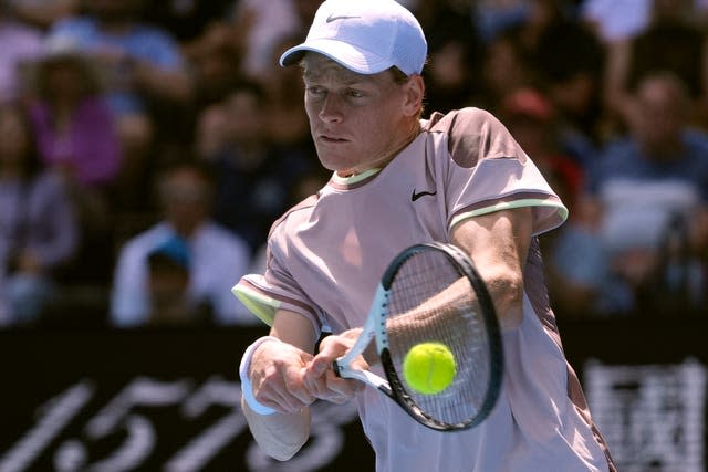 Jannik Sinner hits a backhand