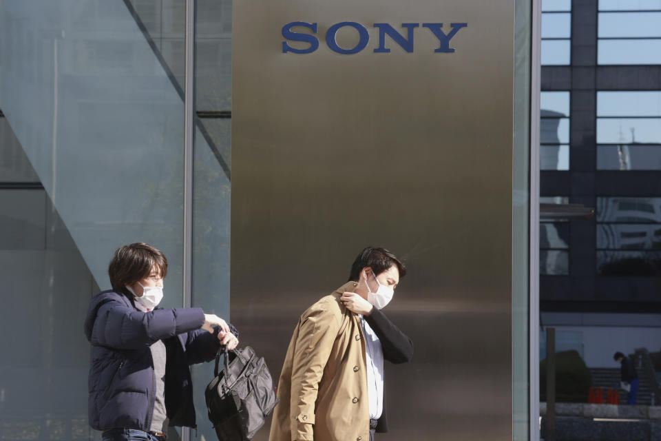 People walk in front of the headquarters of Sony Corp. in Tokyo, Wednesday, Feb. 3, 2021. Sony Corp. reports its fiscal third quarter profit jumped 62%, positioning the Japanese entertainment and electronics giant for a record annual profit as its bottom line got a healthy boost from its mega-hit animation film “Demon Slayer.” (AP Photo/Koji Sasahara)