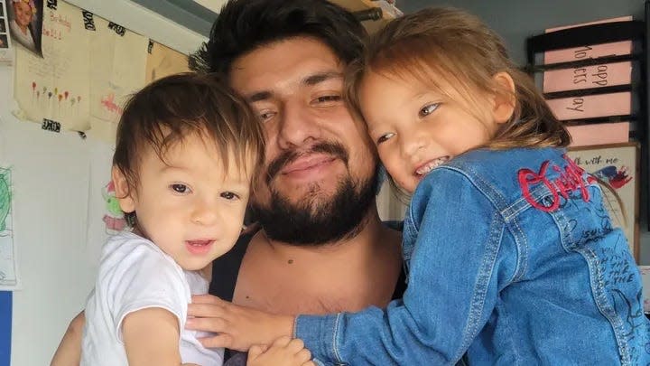 Tommy Solis, 27, of Phelan, pictured with his children in an undated photo.