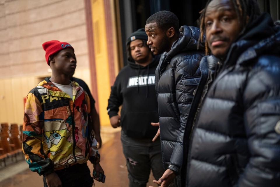 Pershing High School student Marquez Green, left, listens to Darnell Canady, 31, center, of Detroit, a member of the 4s, as he talks with him after speaking with Michael Rogers, 41, right, of Detroit, a member of the 5s, and other rival gang members from the 4s and 5s as they preached peace and an end to violence in the aftermath of the killing of 11-year-old Latrelle Mines that occurred in early January during an assembly at Pershing High School on Thursday, Feb. 1, 2023. Members of Ceasefire, Black Family Development and Detroit Friends and Family also spoke during the historic first time the rival gangs have been under the same roof promoting peace.