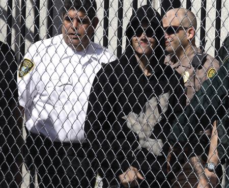 Pop singer Justin Bieber is escorted out of the Turner Guilford Knight Correctional Center in Miami, Florida January 23, 2014. REUTERS/Javier Galeano