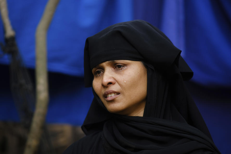 Amina Khatun cries as she speaks about her 18-year-old son, Asmat Ullah, who was on board a boat of 180 Rohingya refugees that vanished in December 2022, during an interview in the Nayapara refugee camp in Teknaf, part of the Cox's Bazar district of Bangladesh, on March 10, 2023. (AP Photo/Mahmud Hossain Opu)