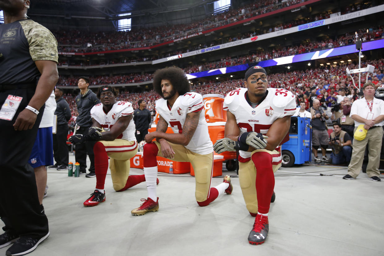 Eric Reid, Colin Kaepernick and Eli Harold took a knee in 2016. (Photo by Michael Zagaris/San Francisco 49ers/Getty Images)