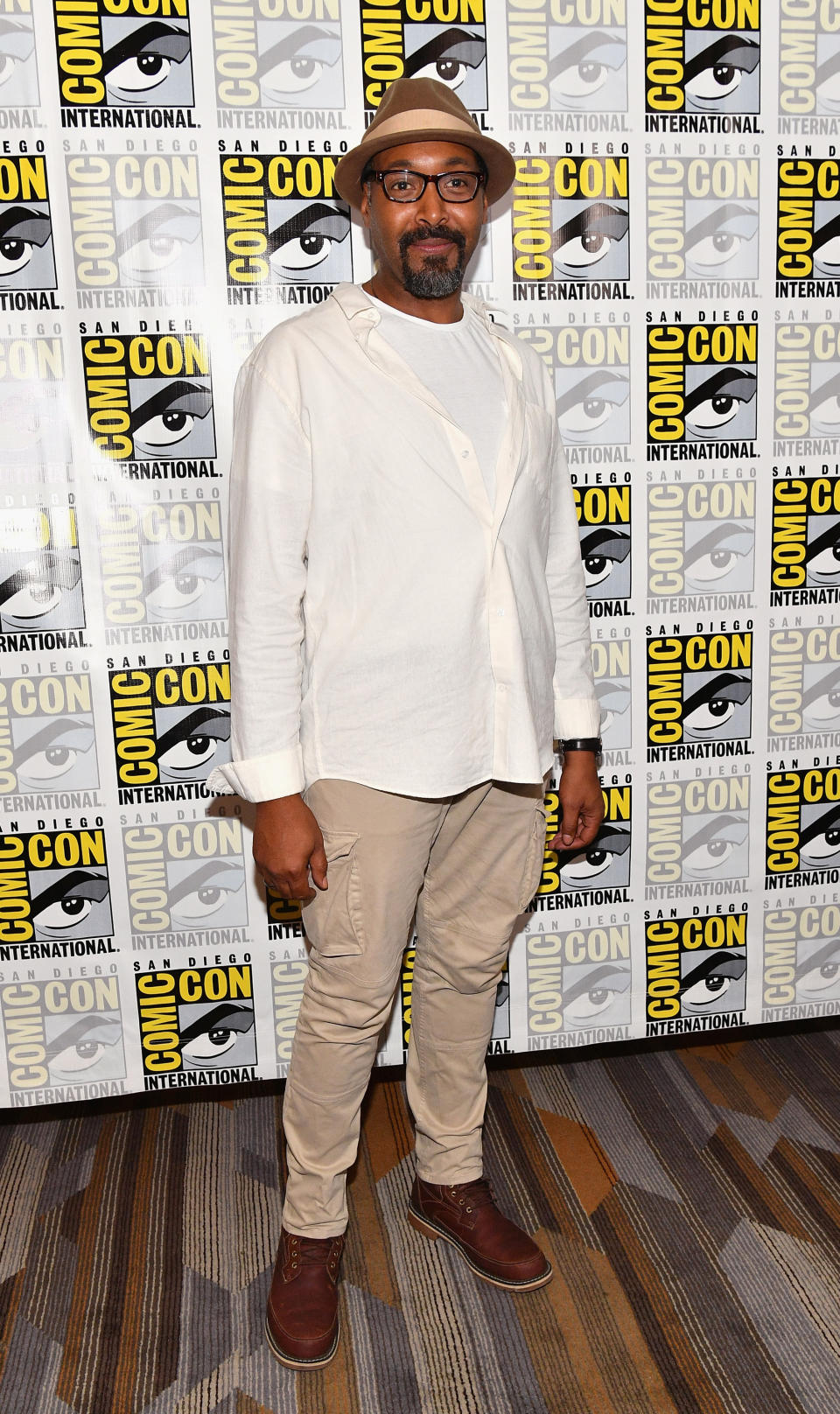 Jesse L. Martin wearing brown.