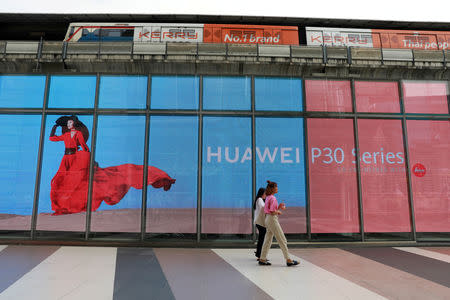 FILE PHOTO: Women walk past a Huawei P30 advertising LED board at a shopping centre in Bangkok, Thailand May 22, 2019. REUTERS/Soe Zeya Tun/File Photo