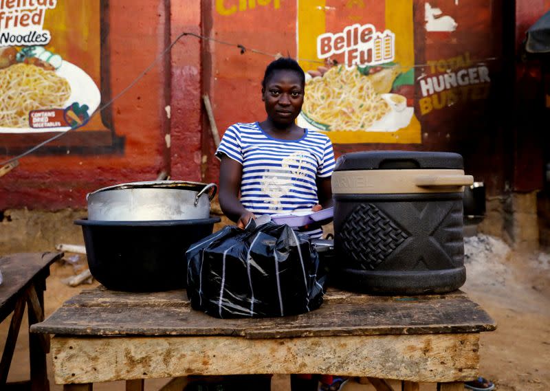 Tijanni Bilikisu, a food vendor poses for a photograph, as authorites continue a 14-day lockdown in a bid to contain the spread of coronavirus disease (COVID 19) in Abuja