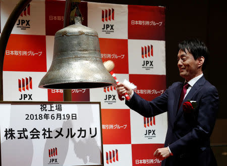 Mercari Inc. CEO Shintaro Yamada rings a bell during a ceremony to mark the company's debut on the Tokyo Stock Exchange in Tokyo, Japan, June 19, 2018. REUTERS/Kim Kyung-Hoon