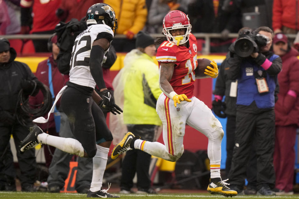 Kansas City Chiefs running back Isiah Pacheco (10) runs against Jacksonville Jaguars cornerback Tyson Campbell (32) during the first half of an NFL divisional round playoff football game, Saturday, Jan. 21, 2023, in Kansas City, Mo. (AP Photo/Charlie Riedel)
