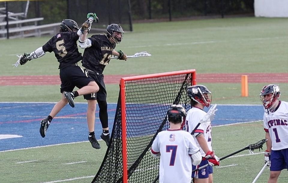 Iona's KJ Delane (5) and Jack Dougherty (12) celebrate Dougherty's go-ahead goal against Stepinac during lacrosse action at Stepinac High School in White Plains May 5, 2022. Iona won the game 9-8.