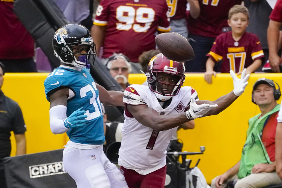 Washington Commanders wide receiver Jahan Dotson (1) catches a touchdown pass against Jacksonville Jaguars cornerback Tyson Campbell (32) during the second half of an NFL football game, Sunday, Sept. 11, 2022, in Landover, Md. (AP Photo/Alex Brandon)